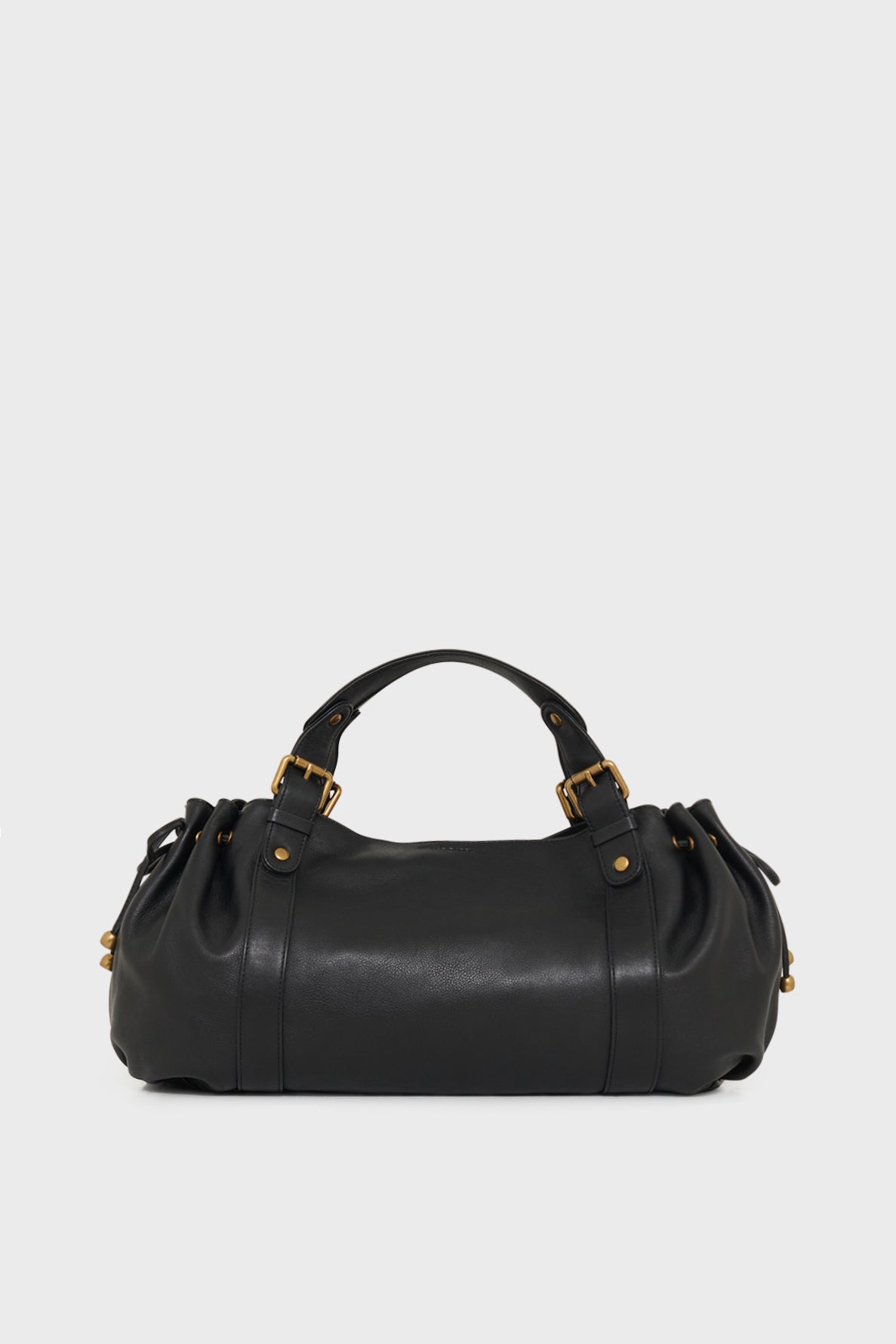 A black leather sac à main with rounded edges, two handles, and gold hardware accents, crafted in the tradition of maroquinerie Darel, displayed against a plain light gray background.