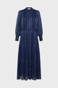 Long-sleeved, navy blue midi dress with vertical metallic stripes in lurex doré, button-down front, tiered skirt, and slight sheen. This robe longue features a classic collar and cuffs, and is displayed against a plain light background.