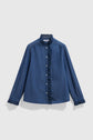 Blue long-sleeve chemise en denim blouse with a ruffled collar, button-down front, and delicate volants trim along the buttons and cuffs, displayed on a plain light background.