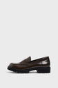 A single dark brown mocassin cuir loafer with a chunky black semelle crantée is shown in a side profile against a plain white background.