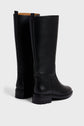 A pair of tall, bottes en cuir noir with low heels and thick rubber soles, positioned on a white background, facing slightly away from the camera. These élégantes bottes femme feature a comfortable bottes talon 4 cm, ideal for everyday wear.
