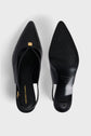 A pair of black pointed-toe escarpins slingback shoes in cuir uni, one showing the insole with Gerard Darel branding, the other revealing the sole with ridged texture and brand details. Featuring a micro talon, their simple, elegant design stands out against a white background.