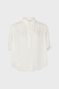 White, loose-fitting blouse with a mandarin collar, partial button placket, subtle floral pattern, and short sleeves featuring small ruffle details at the cuffs. Set against a plain, light background.