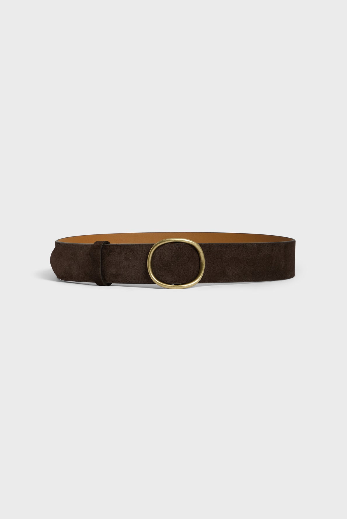 A brown cuir velours belt with a large, round gold buckle displayed against a plain white background, perfect for those who appreciate a ceinture minimaliste.