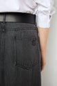 A person wearing a white shirt and dark gray jeans with a back pocket and a black belt, photographed from behind at waist level, evokes the effortless style of a jupe midi en denim in soft, supple fabric.