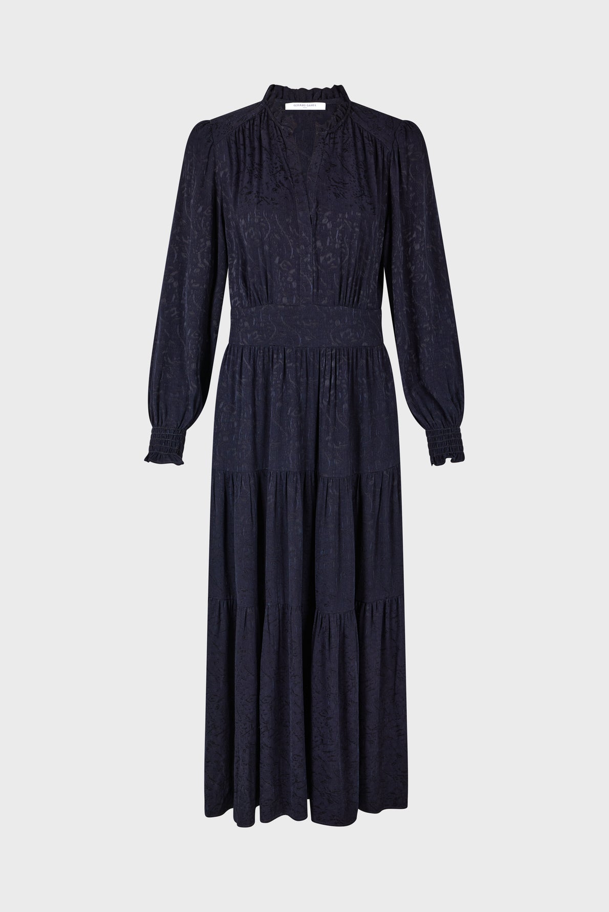 Long-sleeve, ankle-length black dress with a subtle textured pattern, v-neckline, fitted waistband, and tiered skirt, displayed on a plain light background.