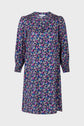 A knee-length, long-sleeve robe courte with a bright motif floral in pink, purple, and white on a dark blue background, featuring a round neckline and slightly gathered sleeves.