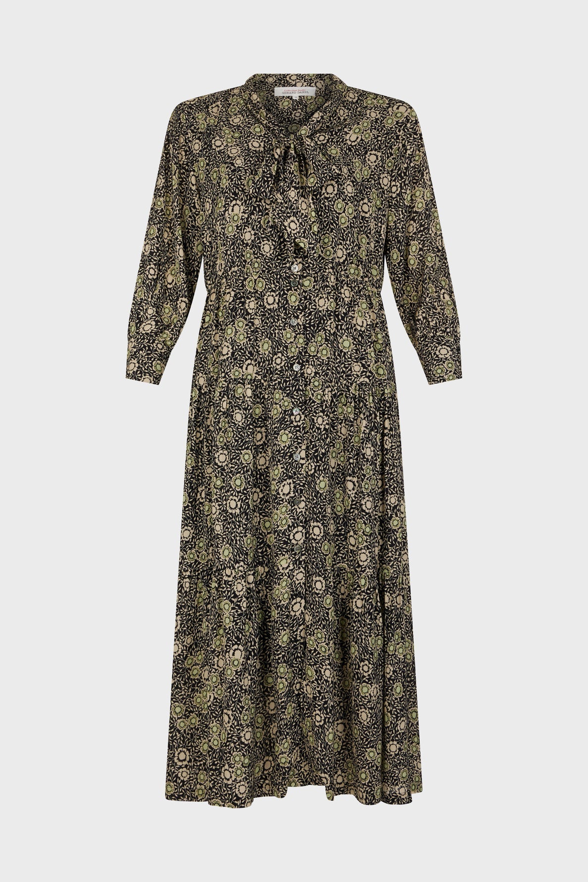 Long-sleeve, midi-length robe longue with a dark motif floral pattern, featuring a col lavallière neckline and button-down front, displayed against a plain white background.