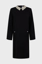 A black robe courte with long sleeves, featuring a col chemise adorned with beaded strass and two flap pockets on the front, each accented by a decorative button, displayed on a plain light background.