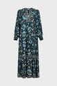 Long-sleeved maxi dress with a blue, green, and black floral pattern inspired by an imprimé végétal motif, featuring a high neck, gathered waist, and jacquard border detailing on the bodice, sleeves, and skirt.
