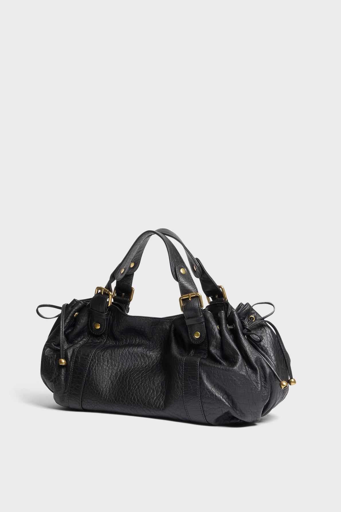 Black leather handbag with gold hardware, short double handles, and gathered detailing on the sides in a chic cuir bubble finish, this sac à main cuir by Darel is elegantly displayed on a plain light background.