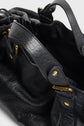 Close-up of a black sac 24H Darel in cuir bubble with gold hardware and textured surface, showing its handle, strap, and partially open top.
