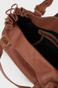 Open brown leather sac à main with gold hardware, showcasing maroquinerie Darel craftsmanship. The bag features a zippered pocket, black interior lining, and a ruffled edge around the opening, all crafted from cuir délicat. A matching brown leather strap completes the elegant design.