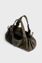 A dark olive green leather sac à main with gold hardware, double handles, side snap details, and an open main compartment. Crafted in the tradition of maroquinerie Darel, this bag features a zippered pocket visible inside for added convenience.