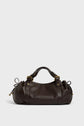 A dark brown cuir délicat leather sac à main with gold hardware, adjustable straps, and side drawstrings, photographed on a plain light gray background—a refined piece of maroquinerie Darel craftsmanship.