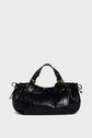 A black leather handbag with short handles, gold hardware, and drawstring details on the sides, crafted in luxurious cuir froissé and echoing the refined elegance of maroquinerie Darel, is set against a plain light grey background.