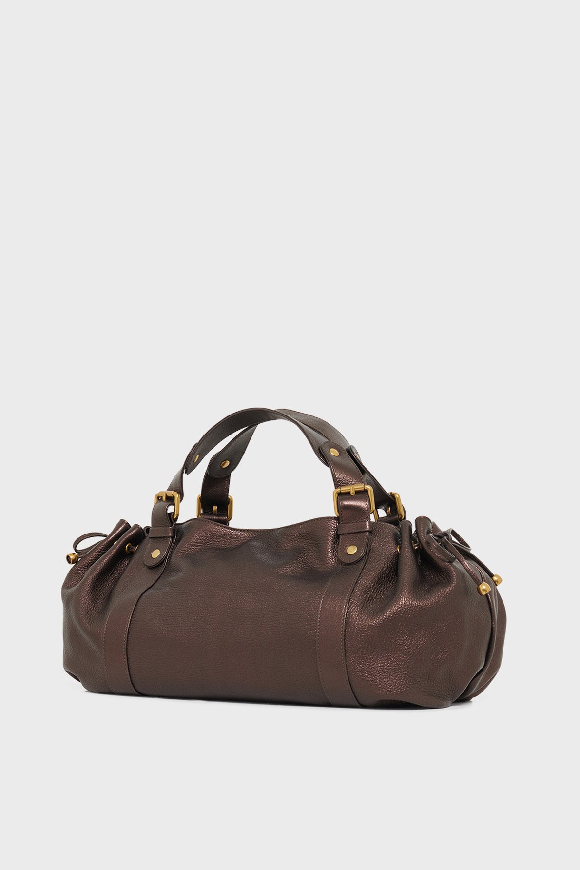 A dark brown cuir de chèvre leather sac à main with gold hardware, double handles, and a slightly rounded shape, placed on a plain white background—a timeless piece reflecting the elegance of maroquinerie Darel.