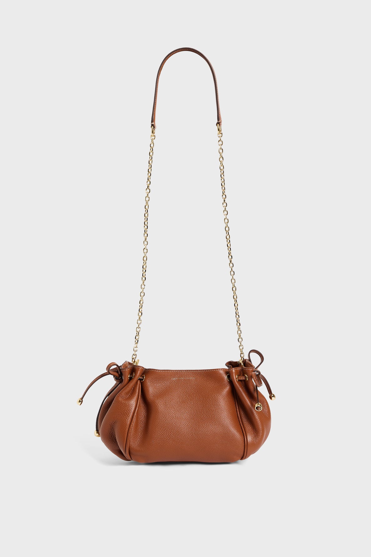 Brown cuir grainé leather handbag by Gerard Darel with a gold chain strap, gathered sides, and small gold hardware accents, displayed on a plain white background.