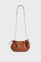 Brown cuir grainé leather handbag by Gerard Darel with a gold chain strap, gathered sides, and small gold hardware accents, displayed on a plain white background.