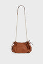 Brown leather Gerard Darel handbag with a gold chain shoulder strap and drawstring details on both sides, crafted in elegant cuir grainé and displayed against a plain white background.