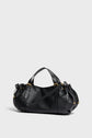 A black Gerard Darel sac à main in cuir grainé with gold hardware, featuring two top handles and a long adjustable shoulder strap, displayed on a plain light gray background.