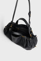 A Gerard Darel black cuir grainé sac à main with gold hardware, featuring two handles and an adjustable shoulder strap. The bag is open, revealing a spacious interior with a zippered pocket.