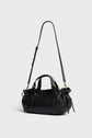 A black sac à main cuir with gold hardware, two short handles, and a long adjustable shoulder strap crafted from luxurious cuir bubble, displayed against a plain light gray background.