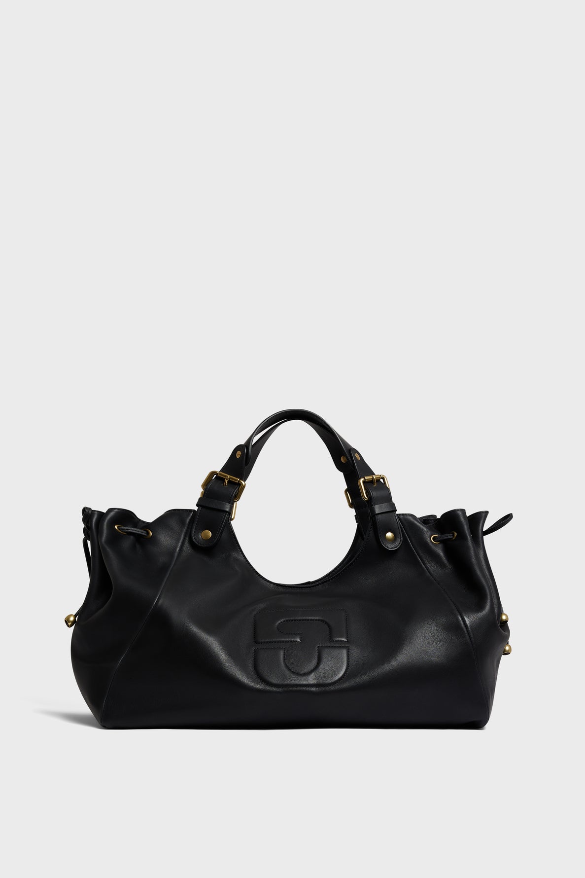 Black leather sac à main with double handles, gold hardware, and a subtle embossed logo on the front, reminiscent of the timeless elegance found in cuir Darel designs, set against a light gray background.