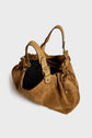 A tan sac à main daim by Maison Darel featuring two handles, gold-tone hardware, drawstring details, and a spacious black-lined interior, is elegantly displayed on a plain white background.