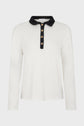 White long-sleeve polo blanc shirt crafted from soft coton, featuring a striking col noir and a black button-up placket adorned with five gold buttons, shown on a plain background.