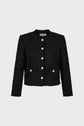 A black, textured, long-sleeve jacket with gold buttons, two front pockets, and a round collar displayed on a plain light background.
