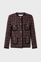 A women’s tweed jacket with a red, white, and black check pattern, black trim, and gold buttons. This chic veste sans col features a round neckline and four front pockets—perfect for adding Parisian flair to any look.