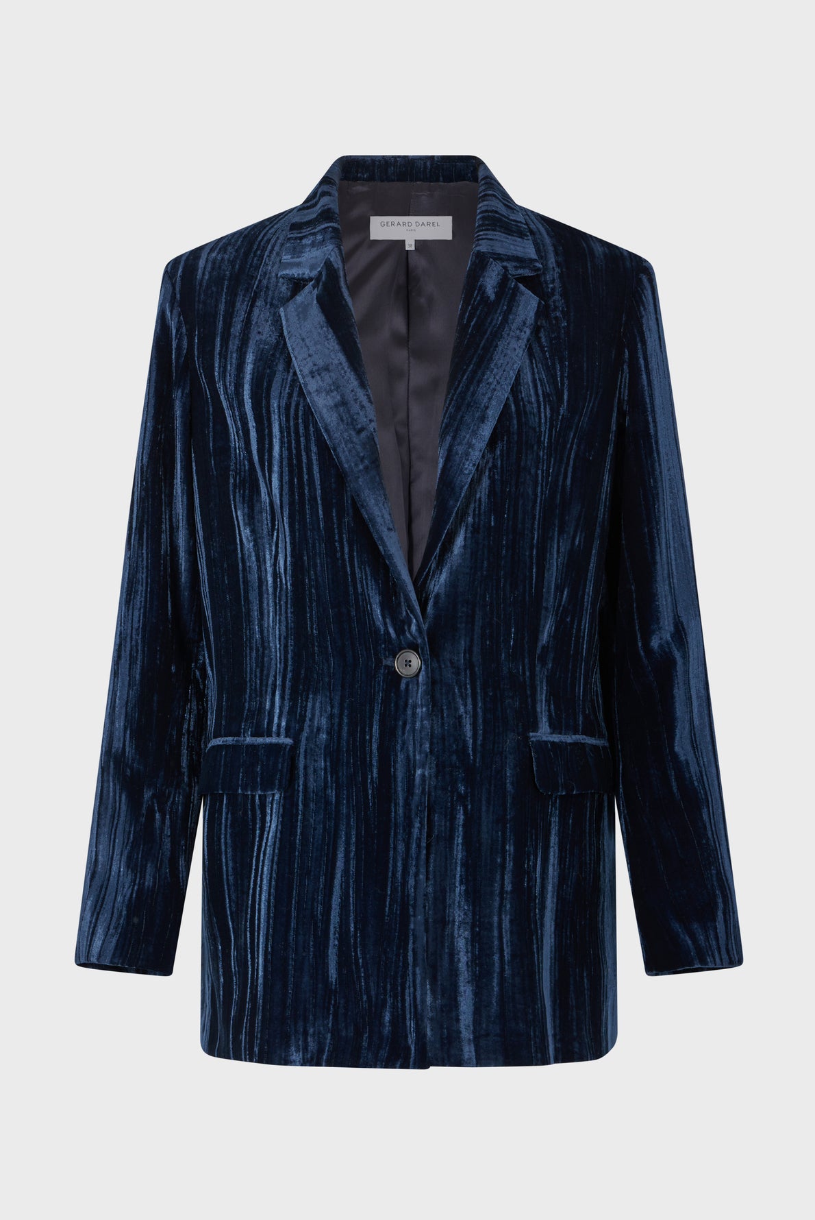 A dark blue velvet blazer with a single button closure, two front flap pockets, and a notched lapel, displayed against a plain white background.
