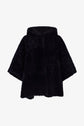 Black faux fur hooded cape with wide sleeves, displayed on a white background. Reminiscent of a classic cape peau lainée, this piece has a soft, plush texture and an oversized fit, giving it a cozy and luxurious appearance.
