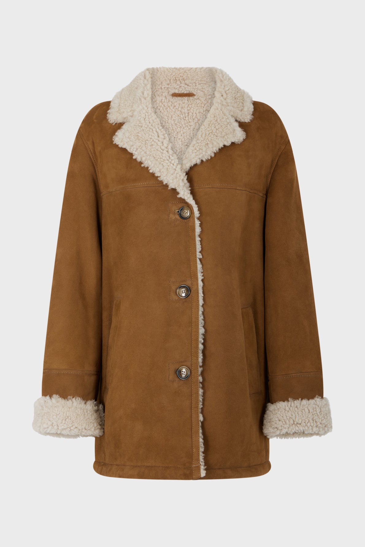 Brown suede coat with cream shearling lining, featuring a wide collar, turned-up cuffs, front buttons, and two side pockets—this manteau mouton velours is displayed on a plain light background.