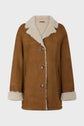 Brown suede coat with cream shearling lining, featuring a wide collar, turned-up cuffs, front buttons, and two side pockets—this manteau mouton velours is displayed on a plain light background.