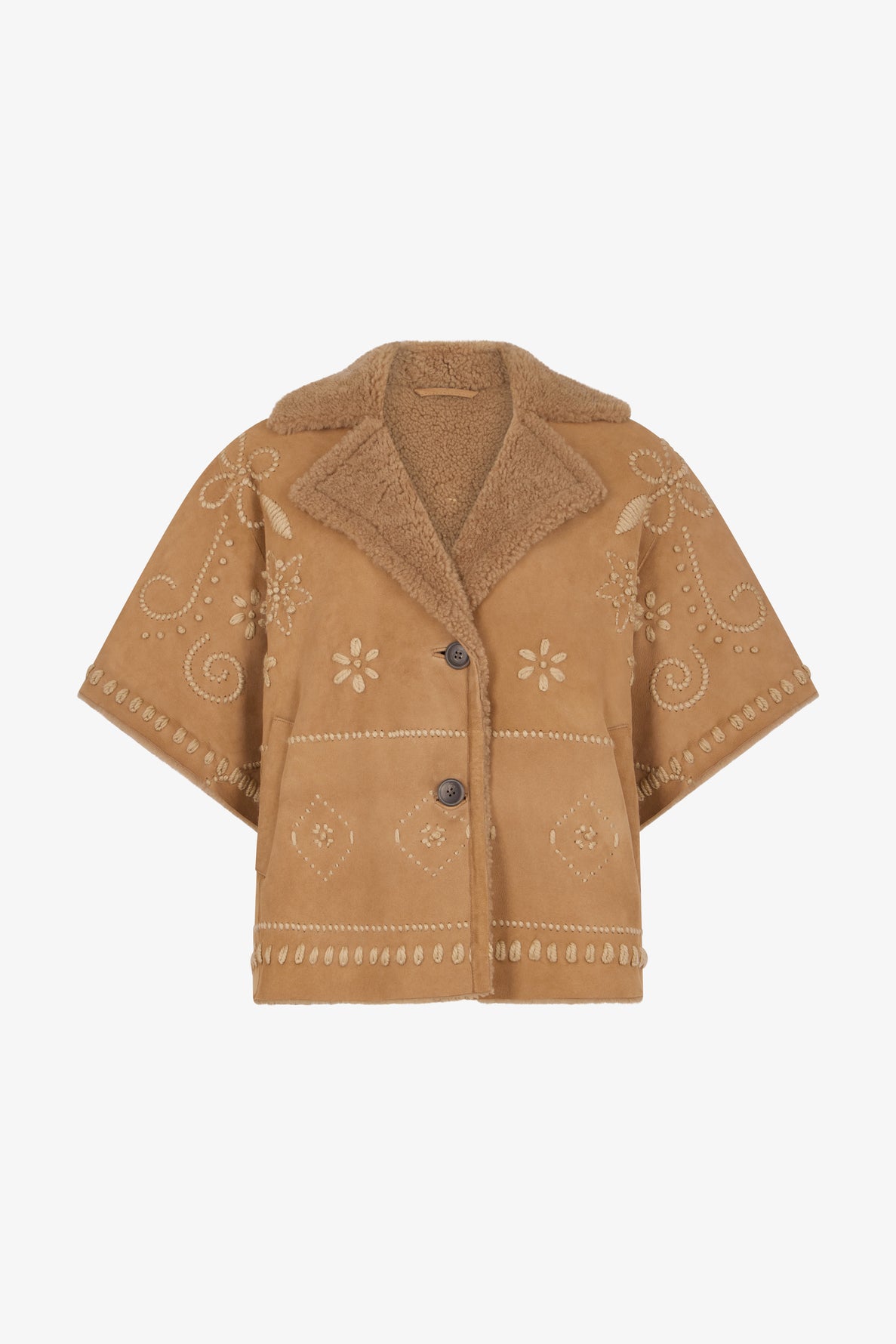 Tan suede short-sleeve jacket with two buttons, featuring fleurs brodées and swirl embroidered designs, and a soft peau lainée lining and collar for added warmth. This veste courte oversize blends comfort with artistic flair.