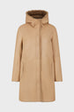 Tan hooded shearling coat with a soft, fuzzy brown lining, visible at the front opening and cuffs. This manteau peau lainée features two vertical side pockets and a straight, relaxed fit, displayed on a plain white background.