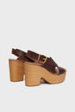Brown leather sandales compensées with wooden chunky heels and gold buckles, displayed against a white background.