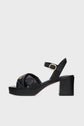 Black heeled sandales à plateforme with a thick block heel, ankle strap with a gold buckle, and a braided front strap featuring a small gold emblem. Carefully fabriquées en Italie, these shoes showcase sleek, modern design and luxurious sophistication.