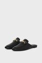 A pair of black leather slip-on loafers with low heels, featuring gold chain detailing on the upper, displayed on a plain white background.