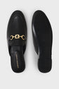 Black leather slip-on loafers with gold chain detail, shown from top and sole view. GERARD DAREL branding visible on the insole of the left shoe. Shoes are displayed on a plain white background.
