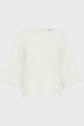 White blouse with elbow-length, flared sleeves and scalloped edges. The fabric features an eyelet floral pattern along the hem and sleeves. The blouse has a round neckline and a simple, elegant design.
