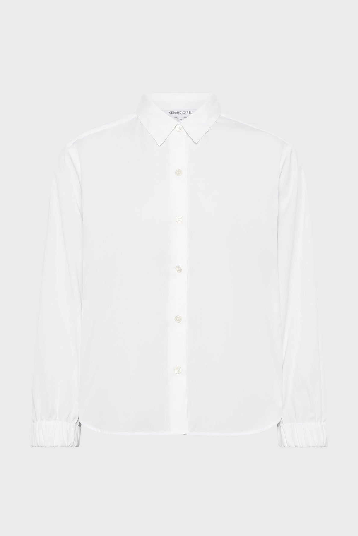 A plain white long-sleeve button-up shirt with a collar and elastic cuffs, displayed on a neutral background.