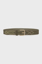 A wide olive green ceinture velours with a gold rectangular buckle and decorative diamond-shaped stud patterns along the length, this ceinture avec studs effortlessly blends elegance with modern flair.
