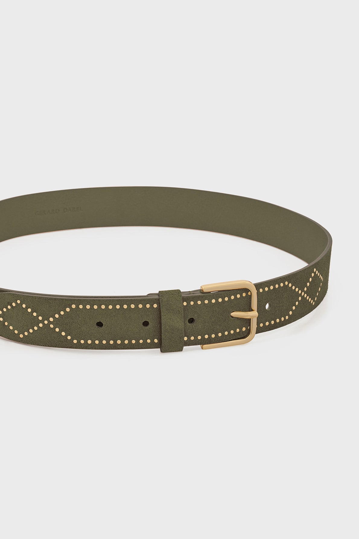Olive green ceinture en cuir with a gold buckle and a gold studded diamond pattern along the strap, displayed against a plain white background.