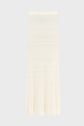 Ivory-colored, ribbed knit midi skirt with a high waist and pleated details at the hem, displayed on a plain, light background.
