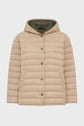 Beige doudoune capuche with front snap buttons and two large front pockets, shown against a plain white background. The jacket features a quilted pattern and an olive green lining inside the hood.