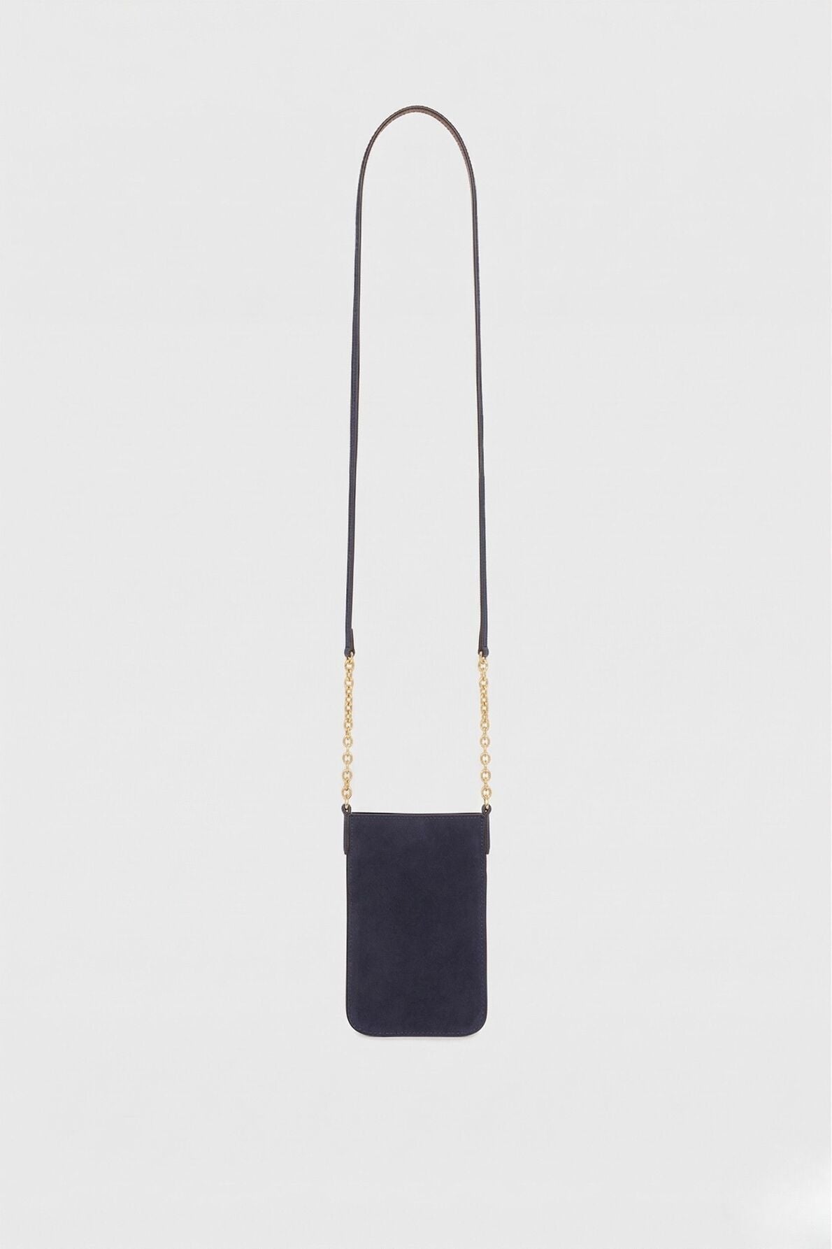 A small black rectangular crossbody bag with a long, thin bandoulière chaîne strap and gold chain accents on both sides, designed as a chic porte-téléphone accessory, set against a plain white background.