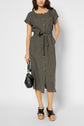 Woman wearing a short-sleeve, button-down, belted midi dress in gray with black platform sandals, holding a small black handbag, standing against a plain background.